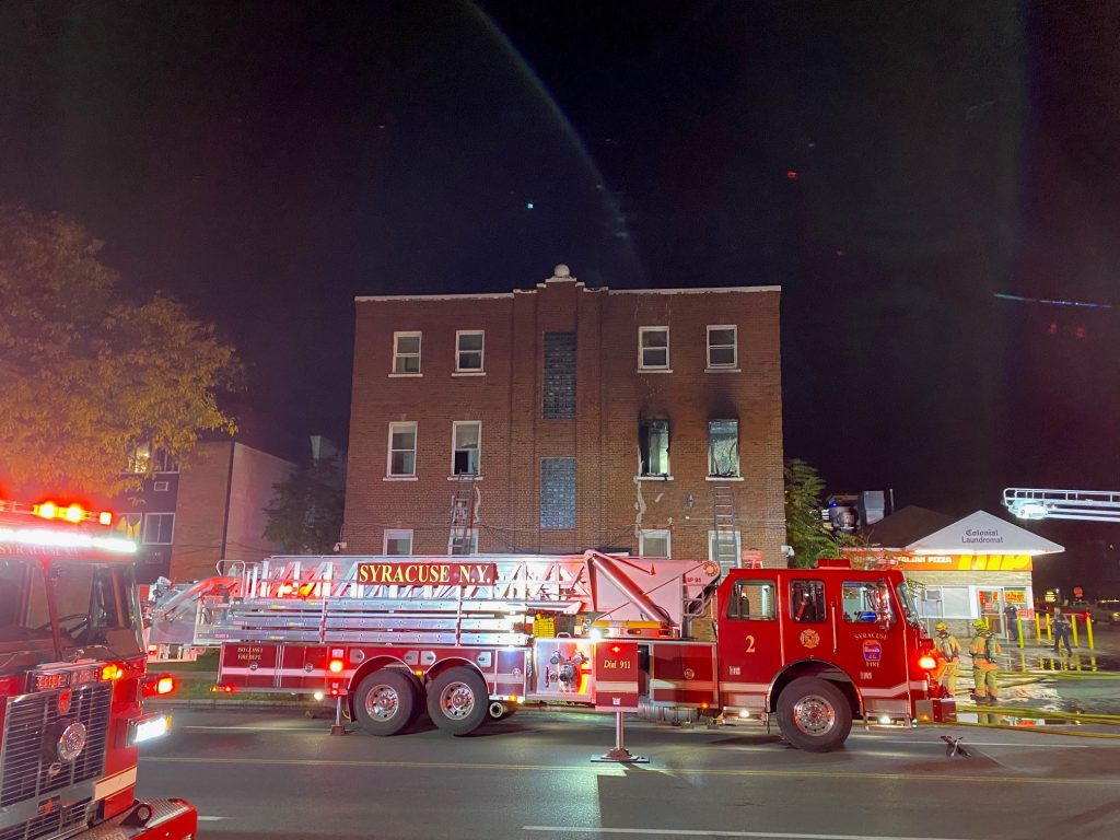 : Truck 2, stationed on Lodi Street, is positioned in front of the building. In the background you can see the burned out windows of the second floor apartment where some of the fire damage occurred.